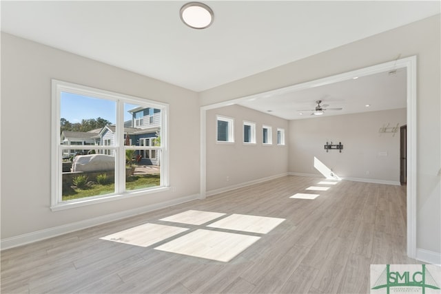 unfurnished living room with ceiling fan and light hardwood / wood-style floors