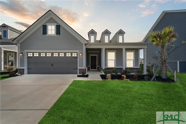 view of front of property with a lawn and a garage