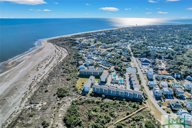 bird's eye view featuring a water view and a beach view