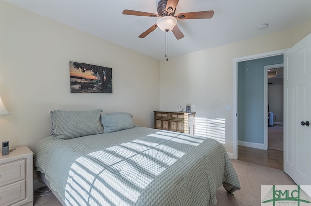 bedroom with ceiling fan and light colored carpet