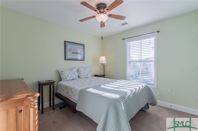 bedroom featuring ceiling fan and light carpet