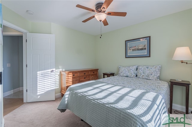 bedroom with light carpet and ceiling fan