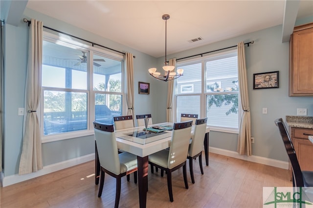 dining room featuring ceiling fan with notable chandelier and light wood-type flooring