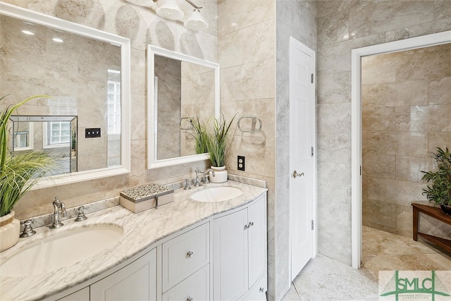 bathroom featuring vanity and tile walls