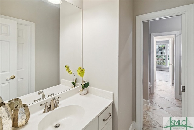 bathroom with tile patterned floors and vanity