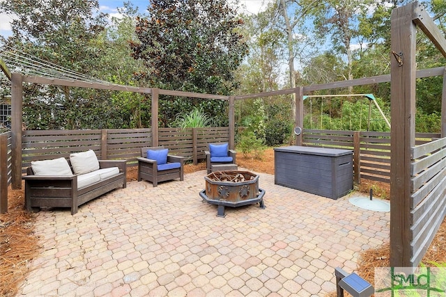 view of patio / terrace with an outdoor living space with a fire pit