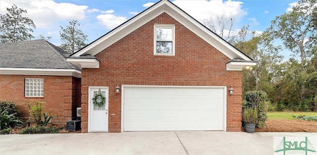 view of property featuring a garage and central air condition unit