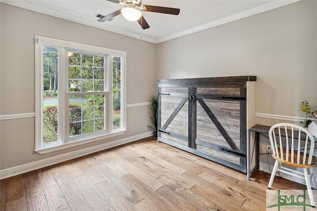 interior space with multiple windows, crown molding, and light hardwood / wood-style flooring