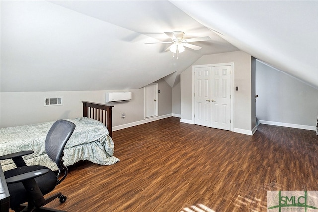 office area with a wall mounted air conditioner, dark hardwood / wood-style floors, ceiling fan, and lofted ceiling