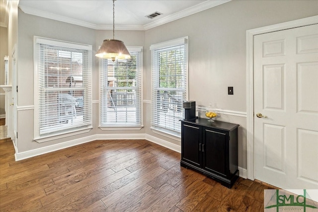 unfurnished dining area with dark hardwood / wood-style floors and ornamental molding