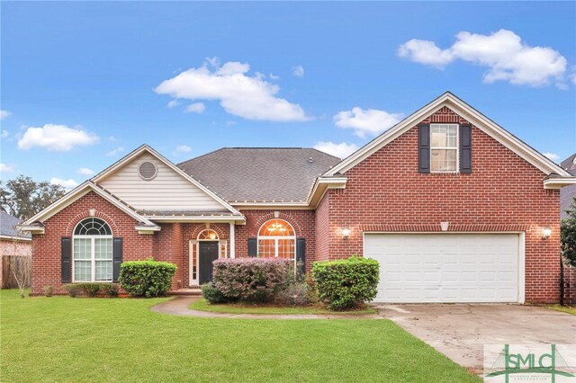 view of property featuring a front lawn and a garage