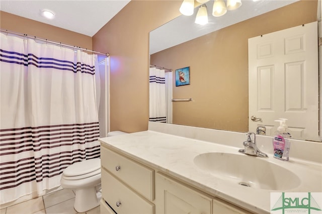 bathroom featuring tile patterned flooring, vanity, and toilet