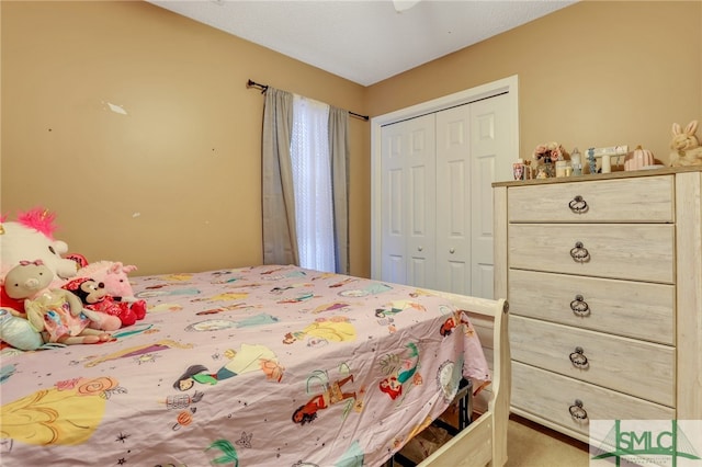 bedroom with carpet and a closet