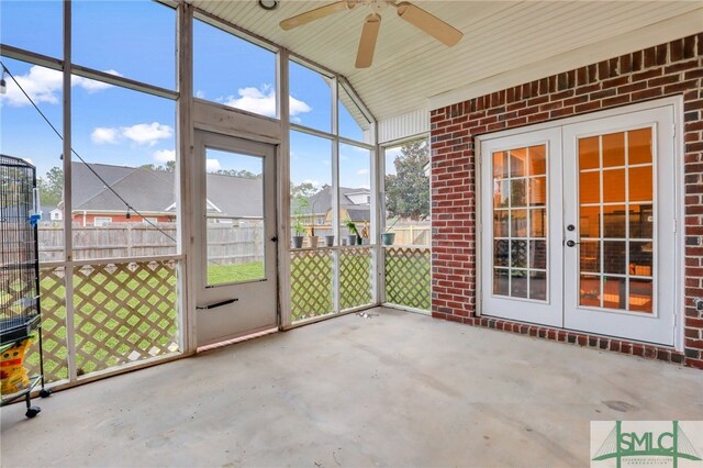 unfurnished sunroom featuring ceiling fan, lofted ceiling, and french doors