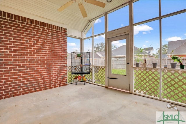 unfurnished sunroom featuring ceiling fan