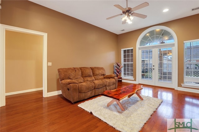 living room featuring ceiling fan, wood-type flooring, and french doors