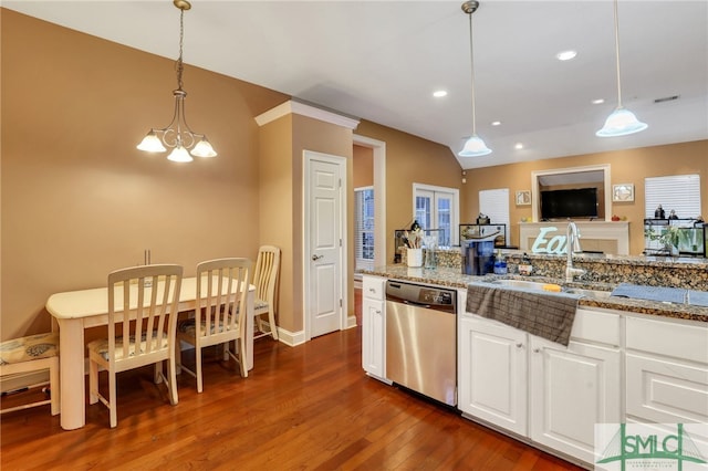 kitchen featuring pendant lighting, dishwasher, white cabinets, light stone countertops, and dark hardwood / wood-style flooring