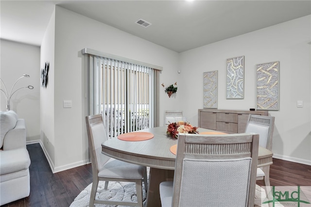 dining space with dark hardwood / wood-style flooring