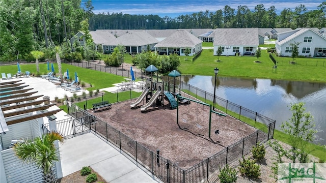 view of jungle gym featuring a lawn and a water view