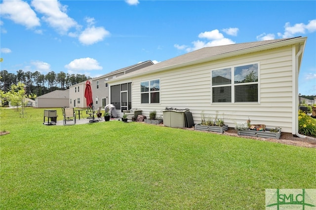 back of house with a yard and a patio