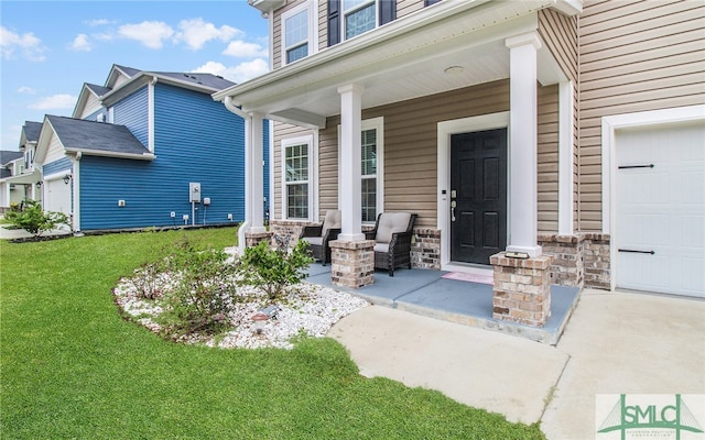 doorway to property with covered porch and a garage