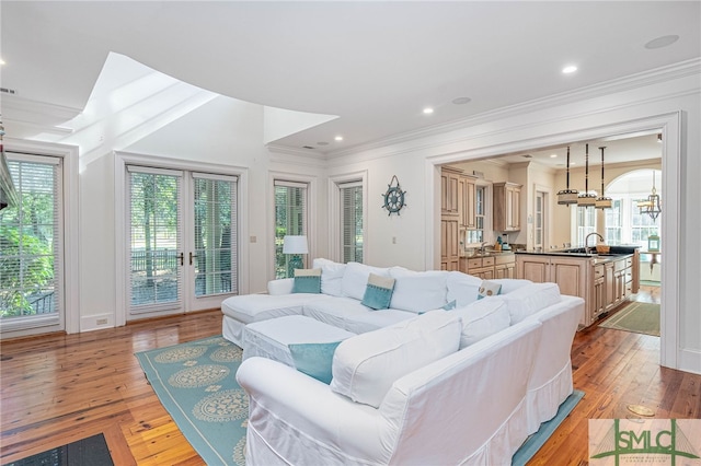 living room with plenty of natural light and light hardwood / wood-style flooring