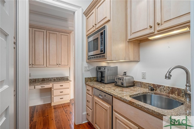 kitchen featuring light stone counters, stainless steel appliances, sink, light brown cabinets, and dark hardwood / wood-style floors