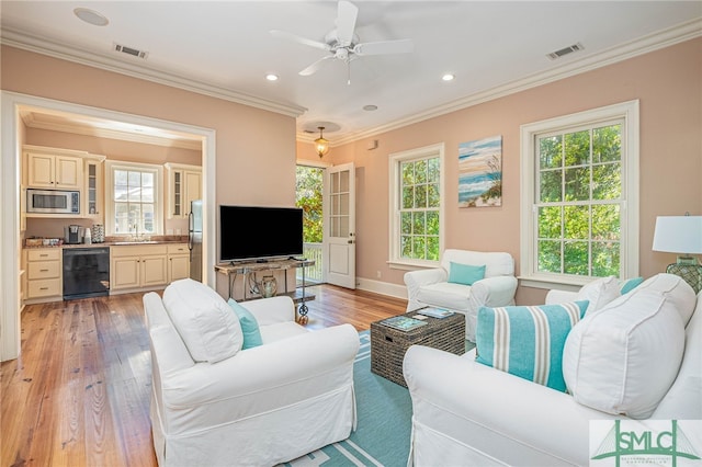 living room featuring sink, crown molding, light hardwood / wood-style flooring, ceiling fan, and beverage cooler