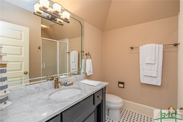 bathroom featuring vanity, a shower with shower door, lofted ceiling, and toilet