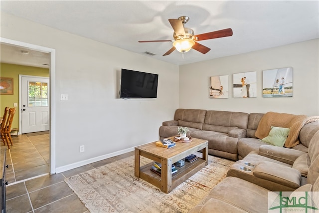 tiled living room featuring ceiling fan