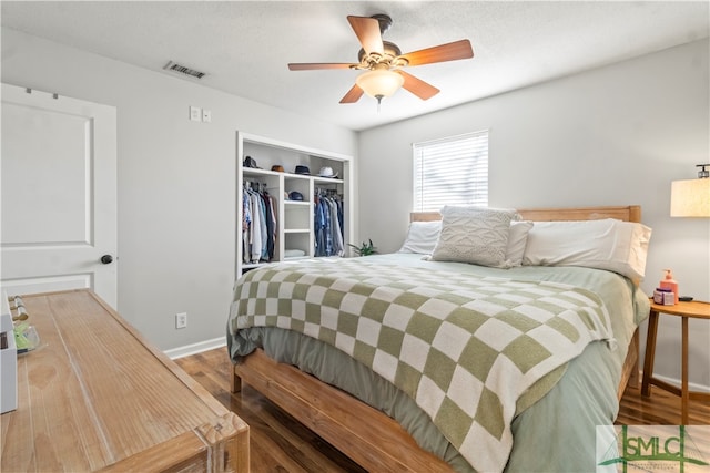 bedroom with ceiling fan, a closet, and hardwood / wood-style floors