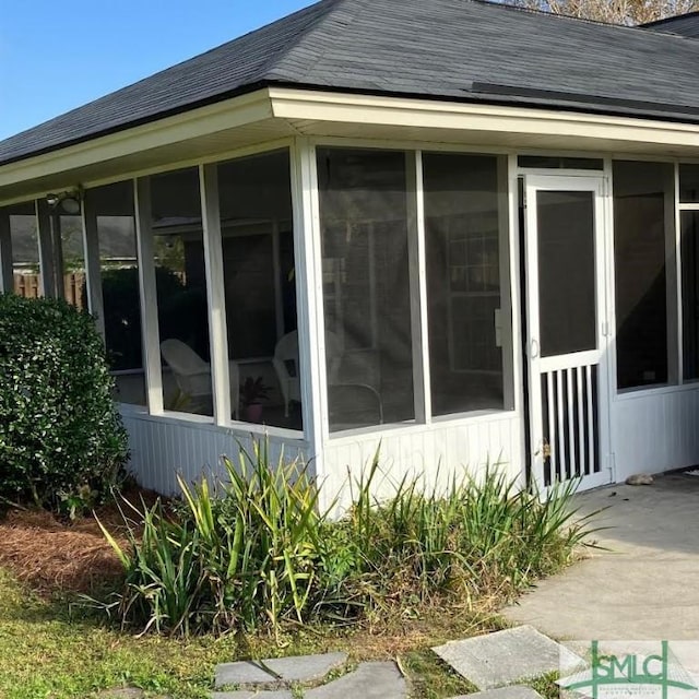 view of property exterior featuring a sunroom