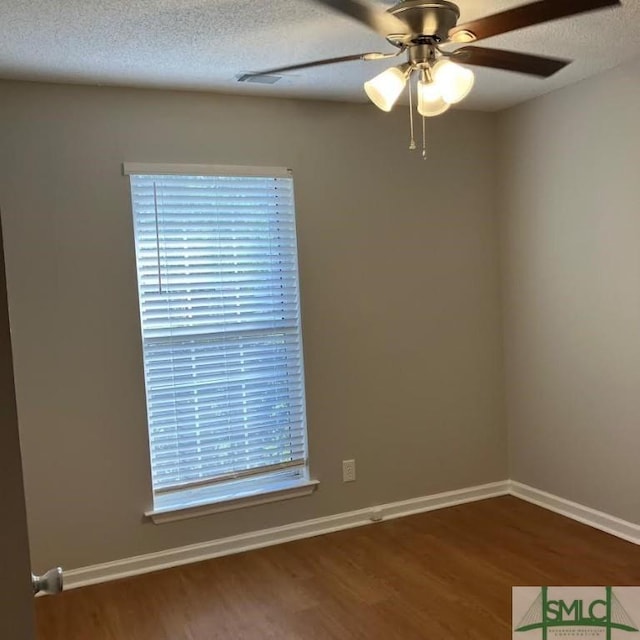 spare room with ceiling fan, wood-type flooring, and a textured ceiling