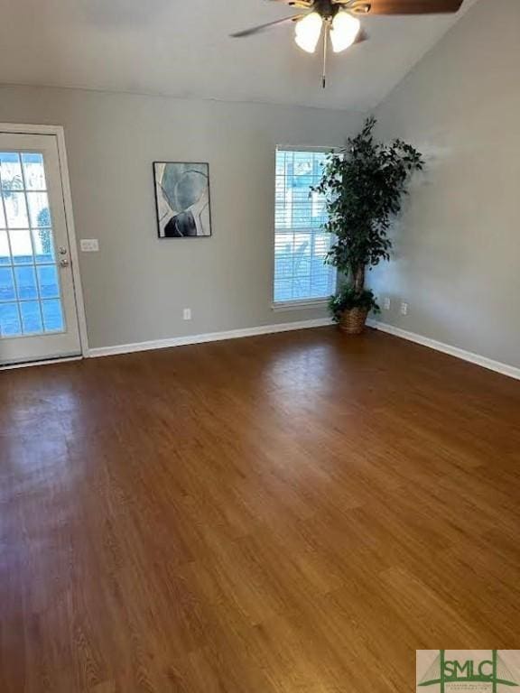 unfurnished room featuring dark hardwood / wood-style flooring, vaulted ceiling, and ceiling fan