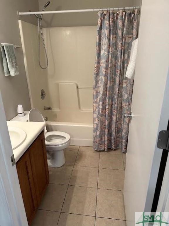 full bathroom featuring vanity, shower / tub combo with curtain, tile patterned floors, and toilet