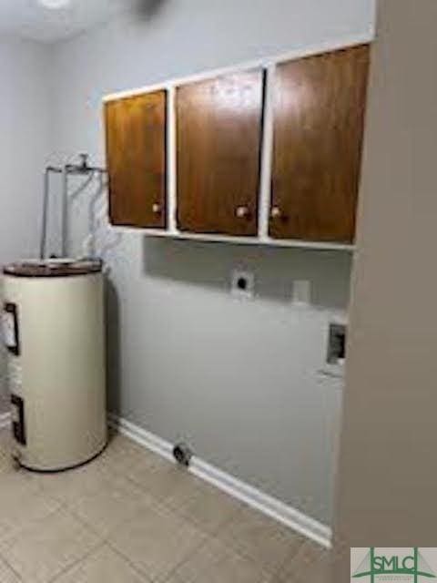 washroom with electric water heater, hookup for a washing machine, cabinets, and hookup for an electric dryer