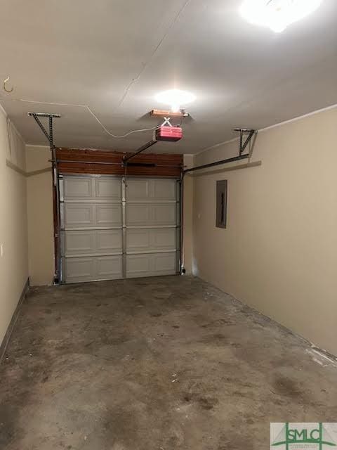 garage with a garage door opener and electric panel