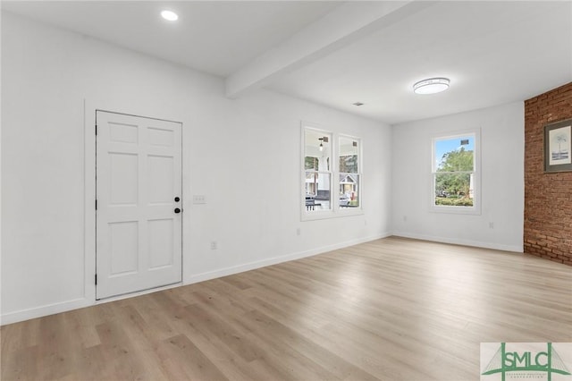 foyer entrance featuring light hardwood / wood-style flooring and beamed ceiling