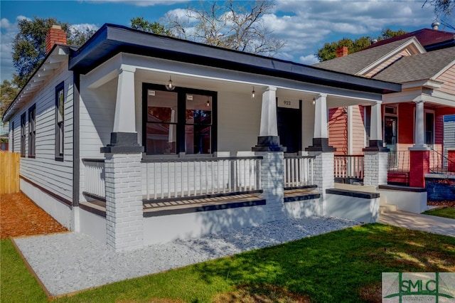 rear view of house featuring a porch