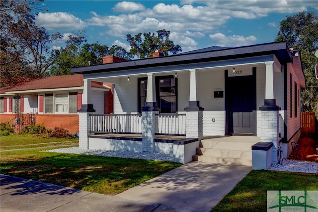 view of front of home featuring a front lawn and a porch