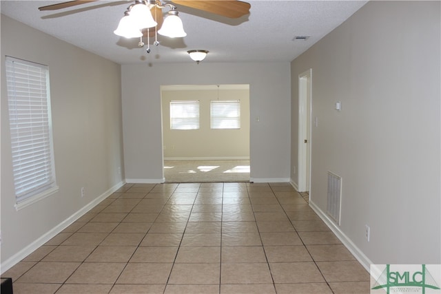 interior space featuring ceiling fan and a textured ceiling