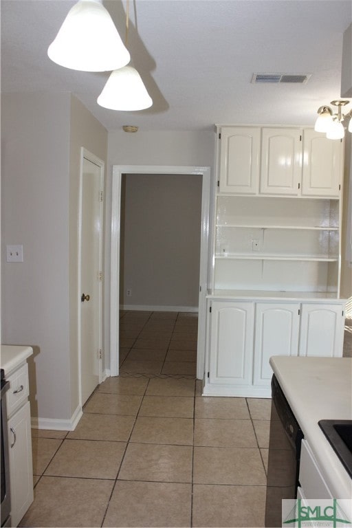 kitchen featuring white cabinetry, dishwasher, and light tile patterned flooring