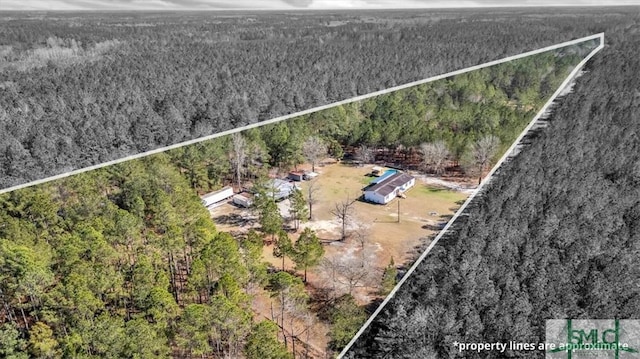 birds eye view of property with a wooded view