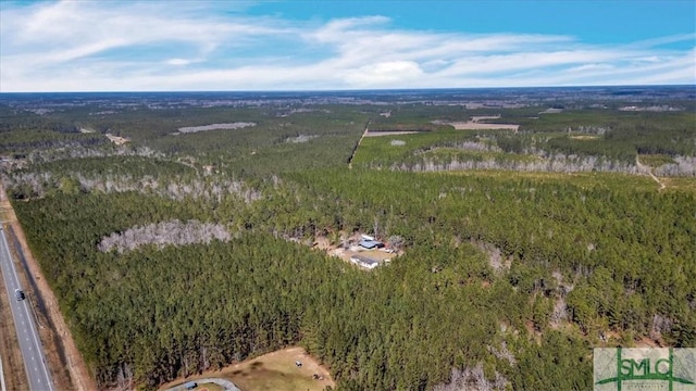 drone / aerial view featuring a view of trees