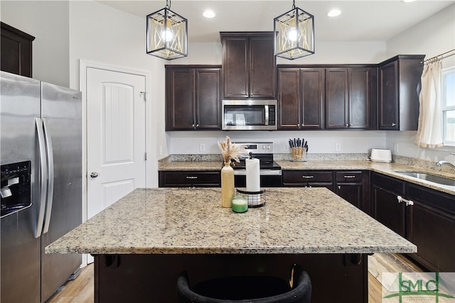 kitchen with pendant lighting, stainless steel appliances, and a kitchen island