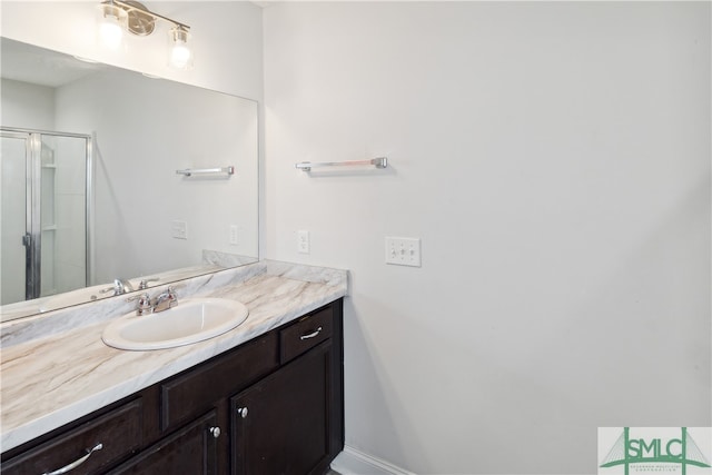 bathroom featuring vanity and a shower with shower door