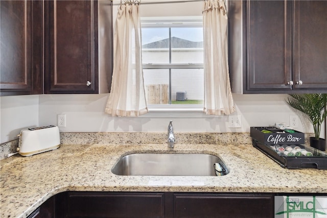 kitchen with light stone counters and sink