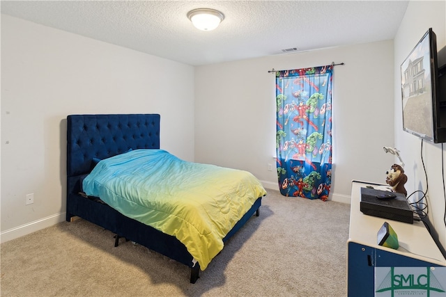 bedroom with carpet and a textured ceiling