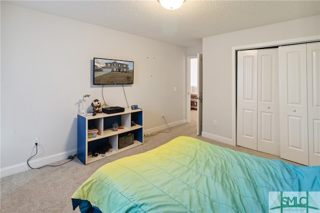 carpeted bedroom featuring a textured ceiling and a closet