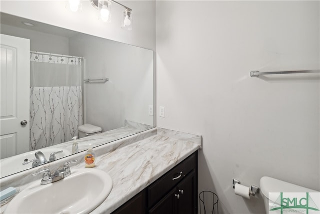 bathroom featuring vanity, a shower with shower curtain, and toilet